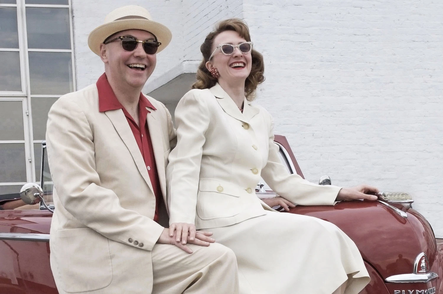 Robin and Colette sat on their 1947 American car